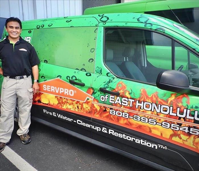owner - male standing next to green SERVPRO vehicle